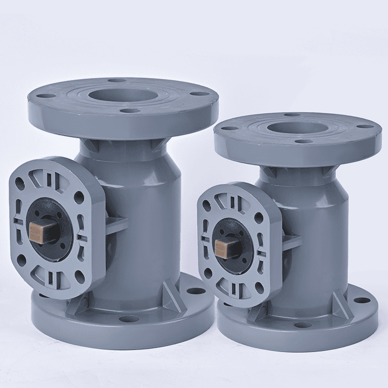 Two CPVC flanged ball valve bodies with mounting pads ready for automated pneumatic or electric actuators