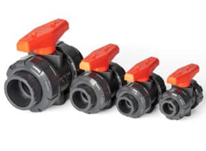 Four UPVC manual true union ball valves displayed in different sizes with red handles, showcasing a complete plastic piping inventory