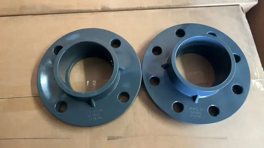 Comparison of a 3-inch ANSI Schedule 80 PVC-U flange with 4 holes and a DN80 DIN PN16 PVC-U flange with 8 holes, showing different standards in industrial plastic valves and fittings